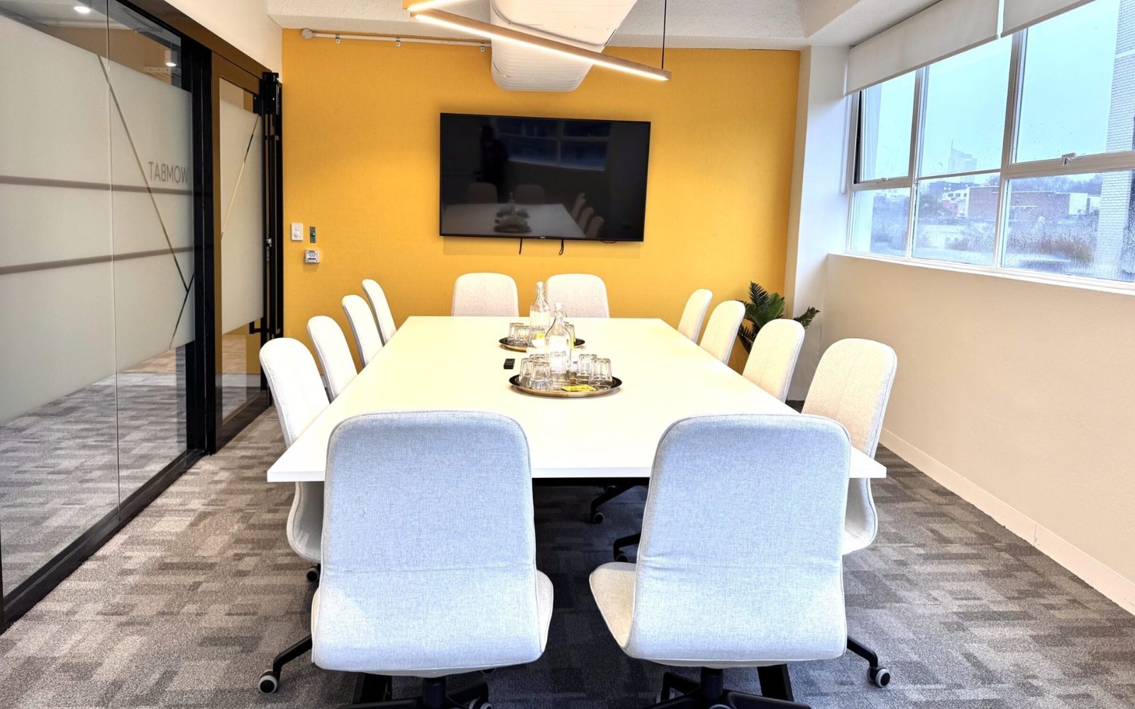 Modern meeting room in Sydney with large screen and boardroom setup