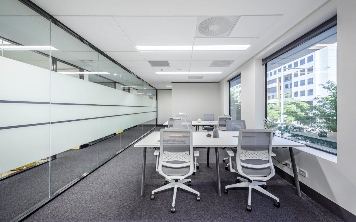 Professional weighing up hot desking vs private office space at JAGA Workspaces in Canberra and Sydney